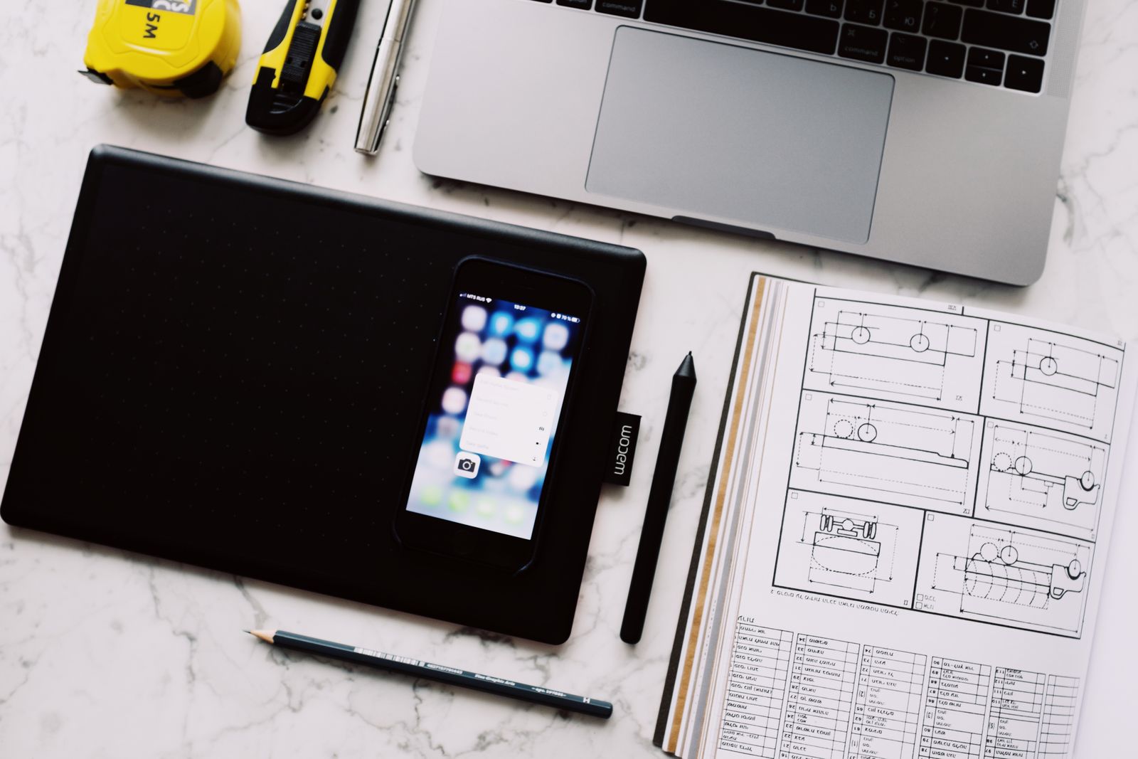 Modern workplace with gadgets and notebook on marble table